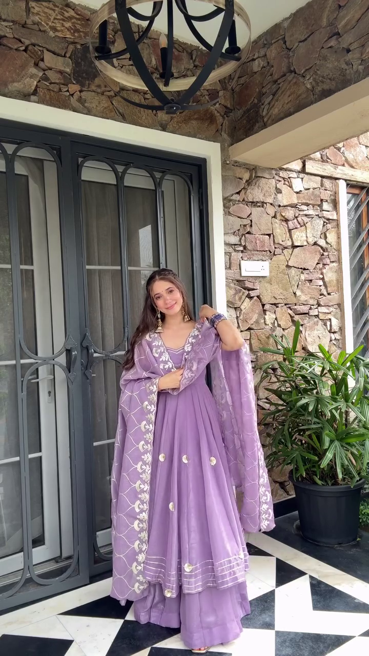 A graceful purple ethnic outfit with floral embroidery and a matching dupatta, exuding elegance and charm. Perfect for festive or traditional occasions.