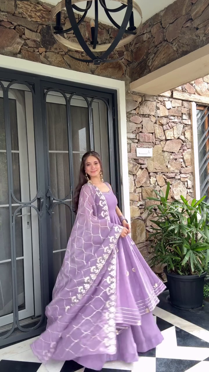 A graceful purple ethnic outfit with floral embroidery and a matching dupatta, exuding elegance and charm. Perfect for festive or traditional occasions.