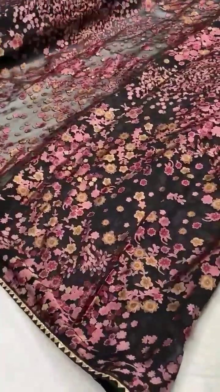 Black Net Saree Featuring All-Over 3D Floral Embroidery in Shades of Pink, Peach, and Gold – Lightweight, Sheer Fabric with Delicate Detailing and Subtle Shimmer, Ideal for Evening Parties, Festive Celebrations, and Special Occasions