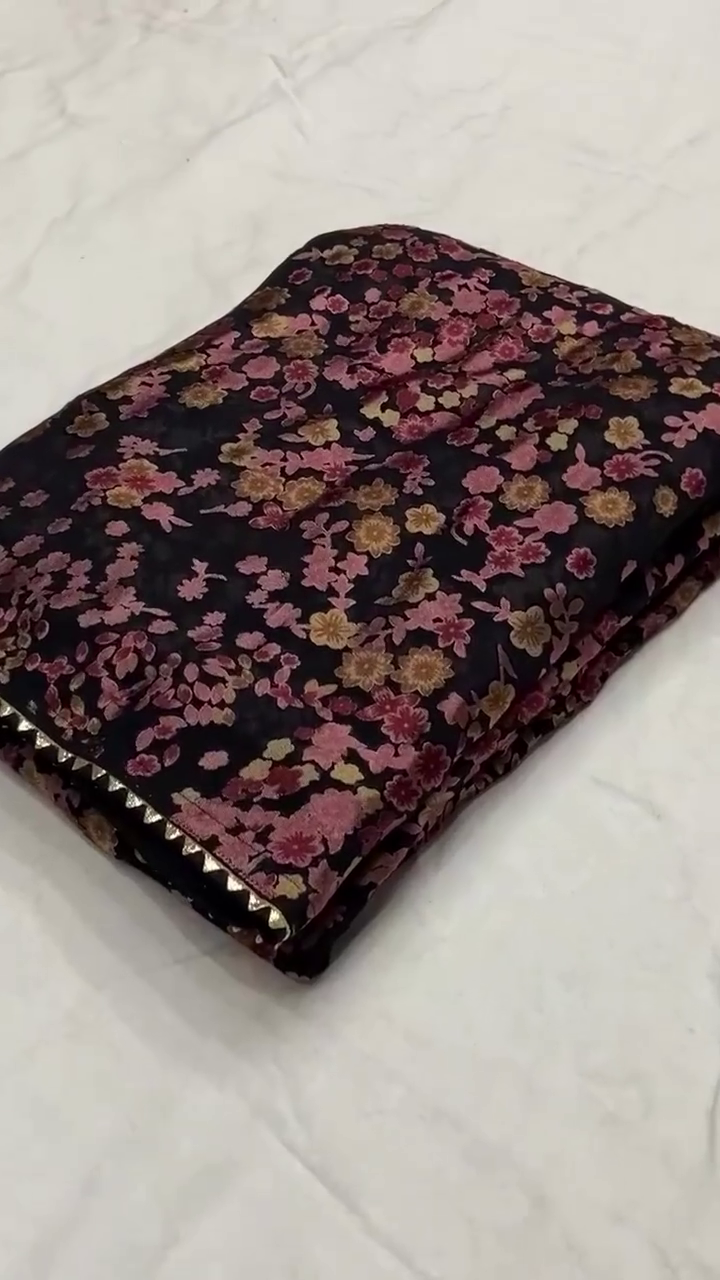 Black Net Saree Featuring All-Over 3D Floral Embroidery in Shades of Pink, Peach, and Gold – Lightweight, Sheer Fabric with Delicate Detailing and Subtle Shimmer, Ideal for Evening Parties, Festive Celebrations, and Special Occasions