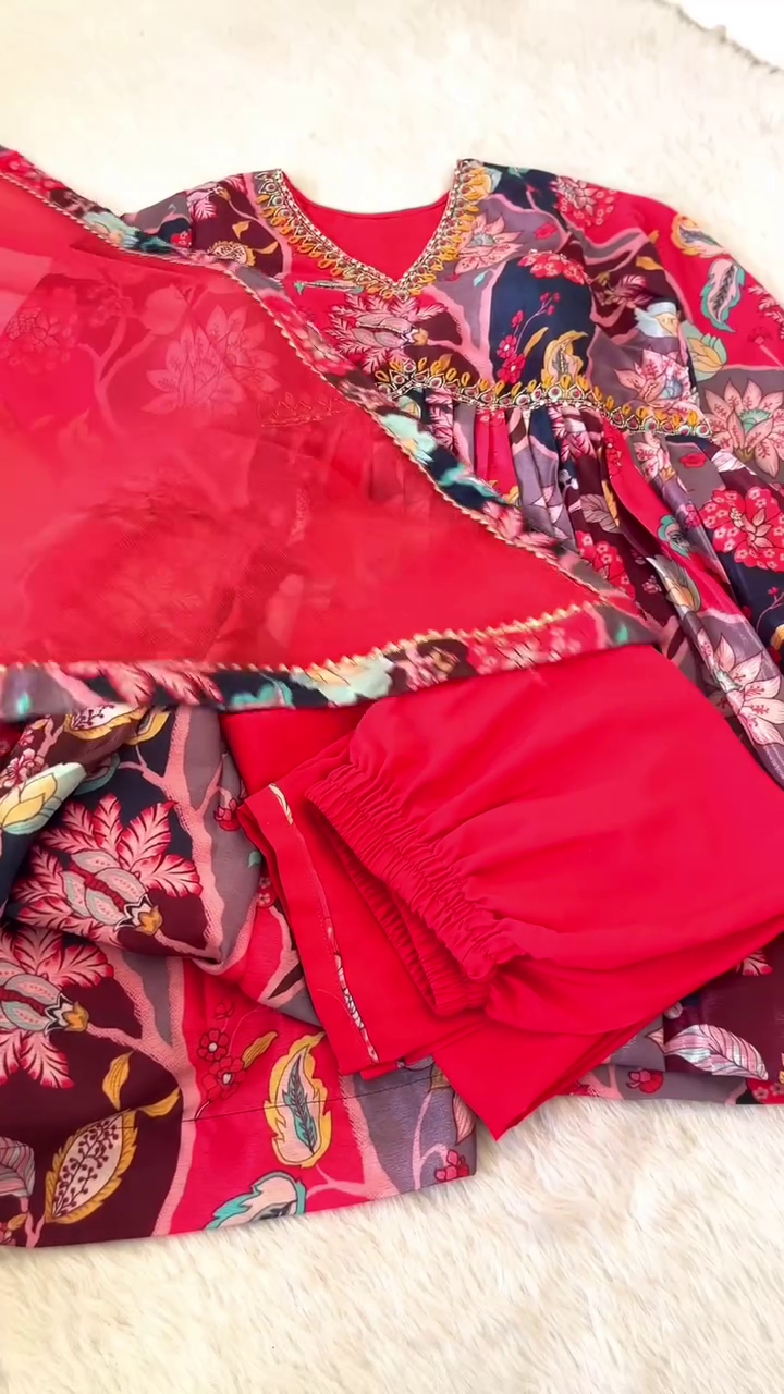 Bold Red and Navy Multicolor Floral Printed Ethnic Suit Set with Heavy Embellished V-Neckline, Matching Soft Net Dupatta with Printed Border, and Coordinated Bottoms – A Striking Choice for Festive and Traditional Occasions
