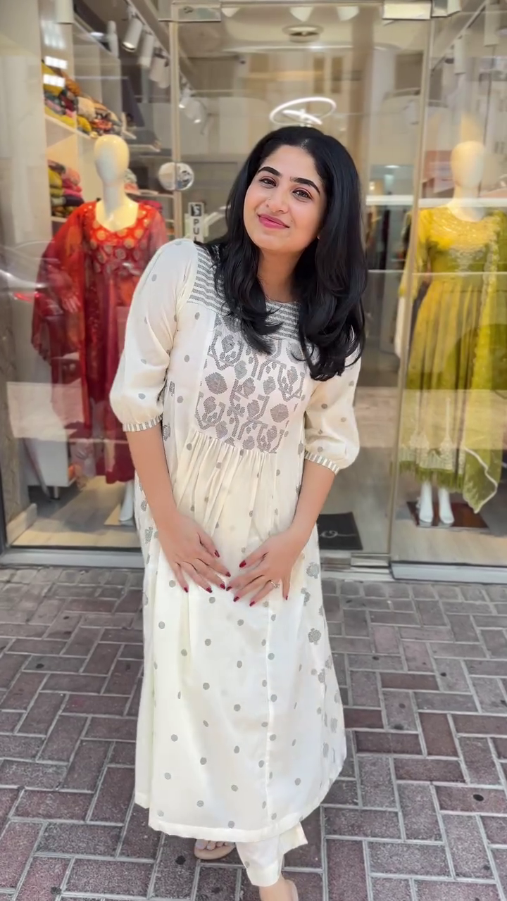 Chic off-white ethnic dress with silver woven motifs and puffed sleeves – A perfect blend of traditional charm and modern ease for casual outings or festive wear.