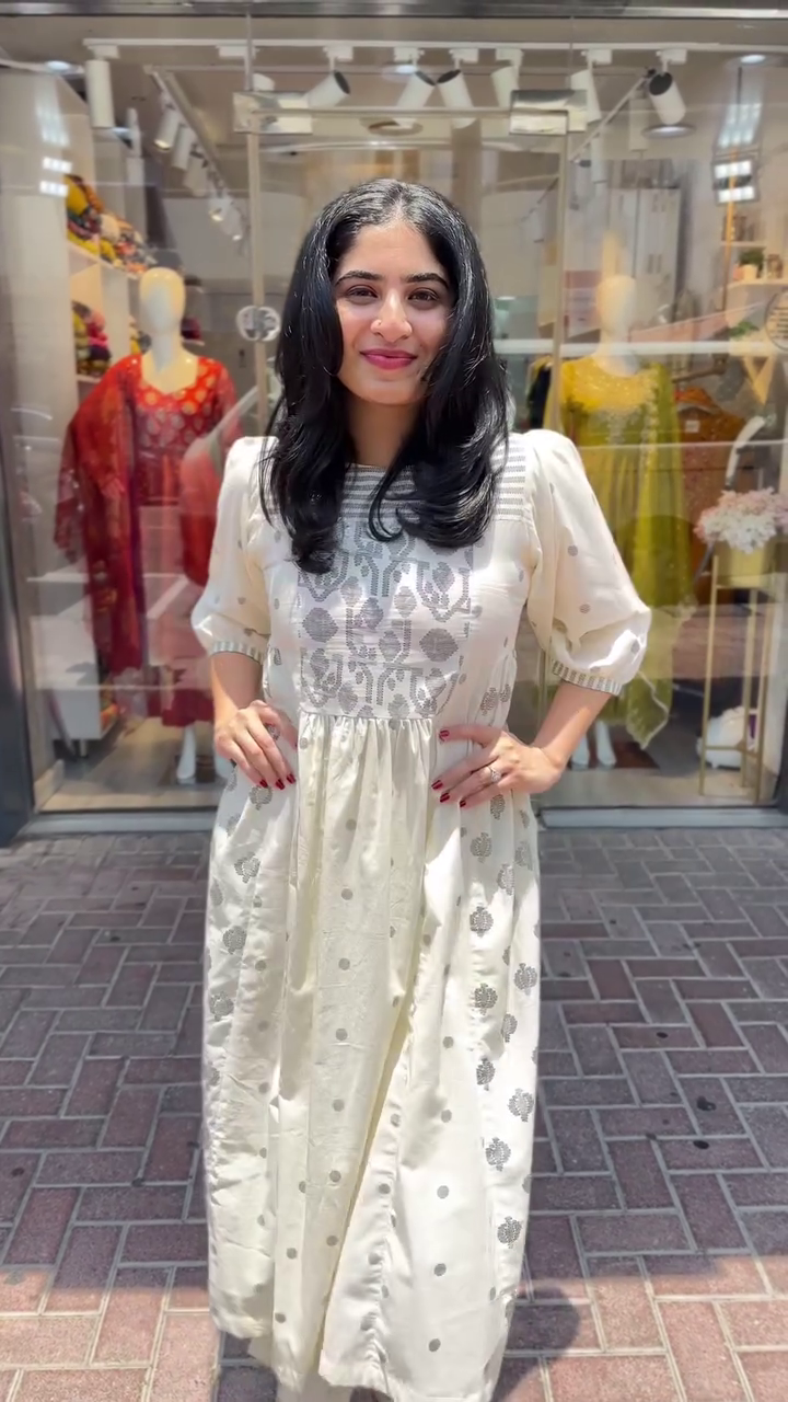Chic off-white ethnic dress with silver woven motifs and puffed sleeves – A perfect blend of traditional charm and modern ease for casual outings or festive wear.