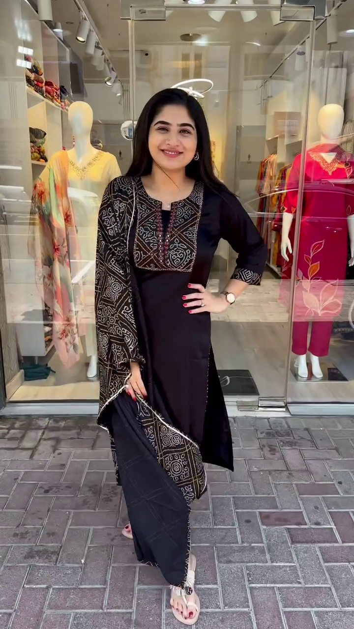 Chic Black Straight-Cut Suit Set Featuring Intricate Multicolor Thread Embroidery on Yoke and Sleeves, Paired with a Coordinated Printed Dupatta – A Striking Choice for Contemporary Festive and Casual Looks