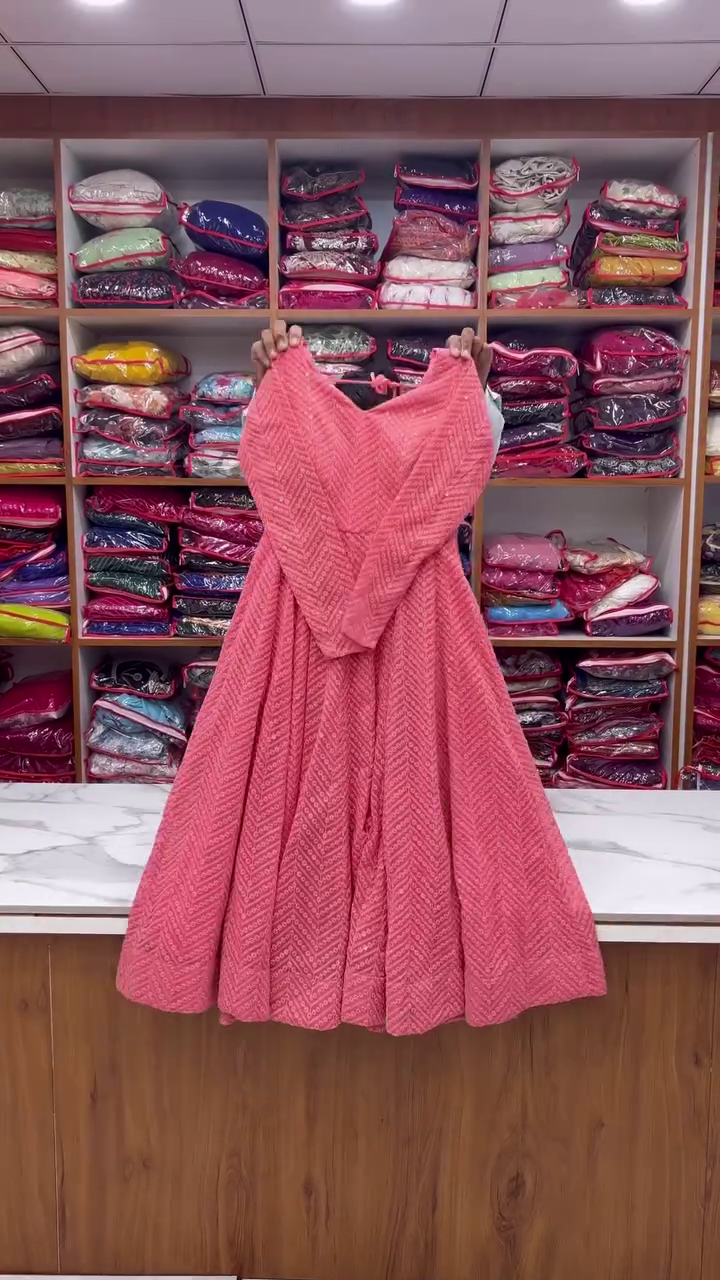 A stunning pink dress with intricate patterns and a flowy look, perfect for any festive or elegant occasion!