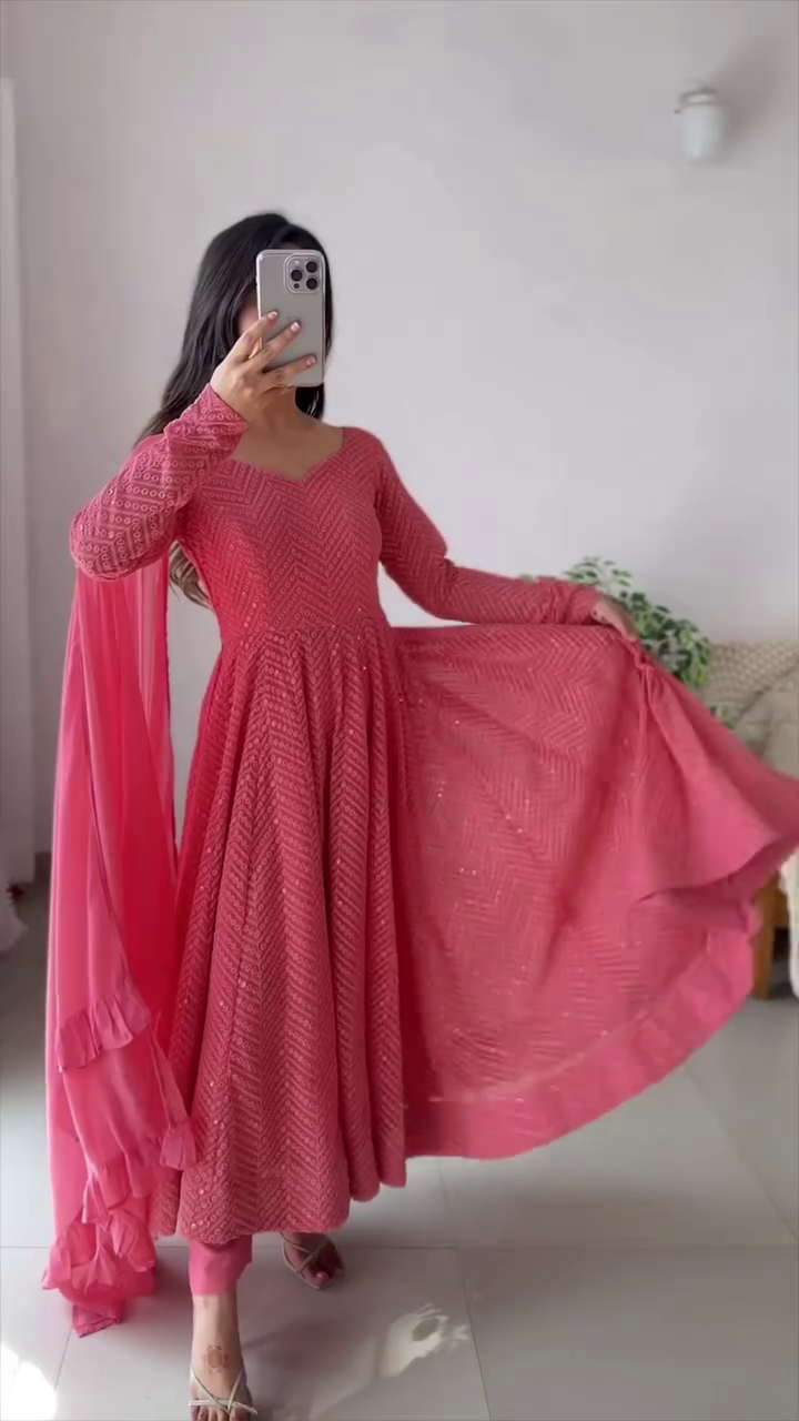 A stunning pink dress with intricate patterns and a flowy look, perfect for any festive or elegant occasion!