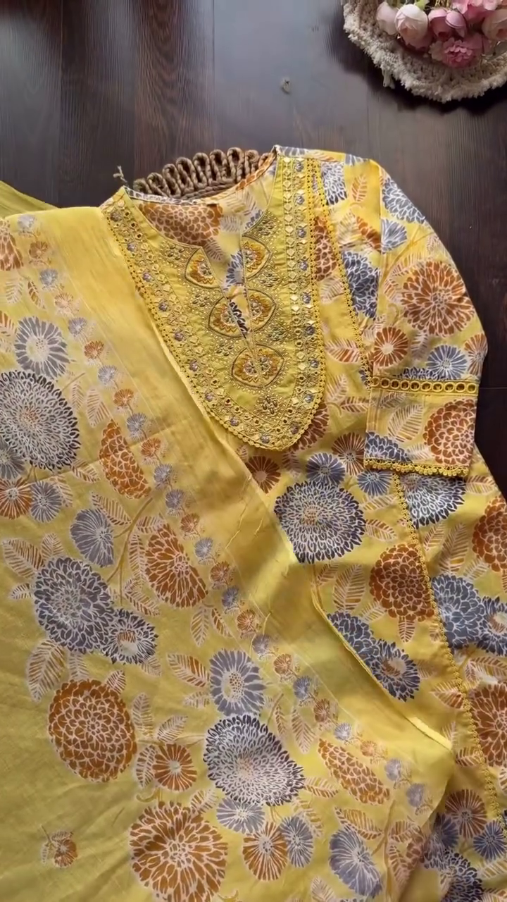 A cheerful yellow floral dress with intricate embroidery on the neckline, perfect for a sunny day outing or a casual gathering.     Ask ChatGPT