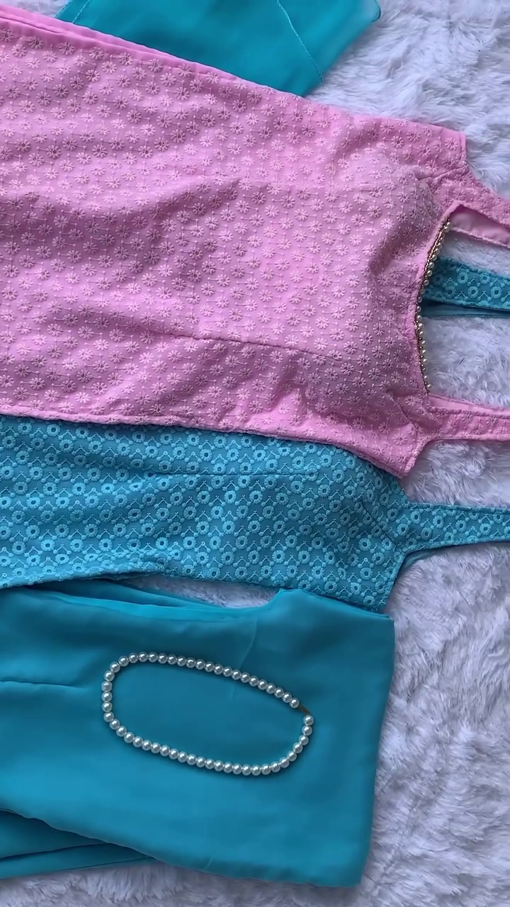 A vibrant combo of pink and turquoise outfits with delicate floral designs, paired with a classy pearl necklace. Perfect for a chic and fresh look!