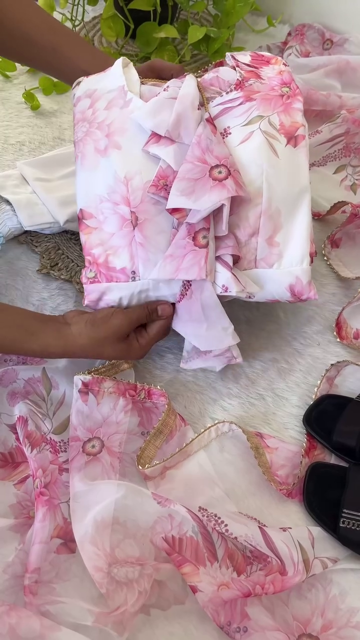 Charming Pink Floral Organza Partywear Set Featuring Ruffle Detailed Top with Sheer Layered Cape, Matching Printed Skirt with Net Underskirt for Added Flare, and Coordinated White Bottoms – A Perfect Blend of Elegance and Grace for Special Occasions