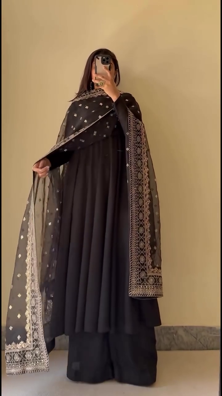 Black Anarkali Suit Set Featuring Flared Silhouette with Matching Wide-Leg Bottoms, Paired with Sheer Embroidered Dupatta Accentuated with Intricate Golden Threadwork and Border Detailing – Perfect for Festive and Traditional Occasions
