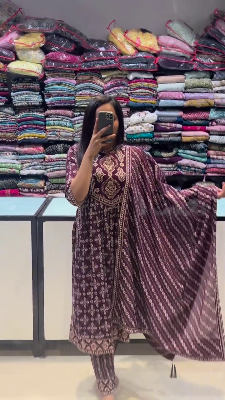 Elegant maroon ethnic set featuring intricate traditional motifs in beige. Complete with a matching dupatta and churidar, this suit exudes classic charm for everyday or festive wear.
