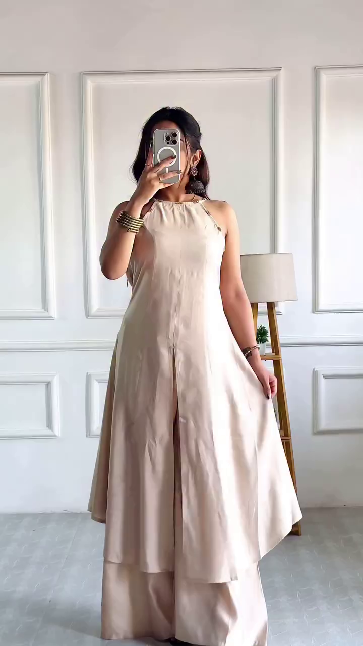 Halter-Neck Flared Indo-Western Jumpsuit with Layered Detailing and Chic Sleeveless Design Paired with Printed V-Neck Anarkali Kurti Featuring Floral Motifs and Blue Striped Pants for a Contemporary Ethnic Look