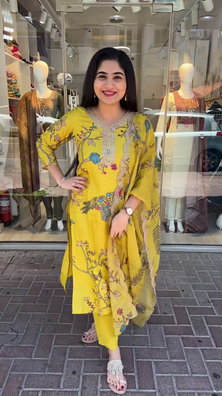 Mustard Yellow Cotton Kurta Set Colorful Floral and Botanical Print with Embroidered Neckline, Paired with Matching Pants and a Coordinated Printed Dupatta Accentuated with Scalloped Detailing – Perfect for Summer Festivities and Everyday Elegance