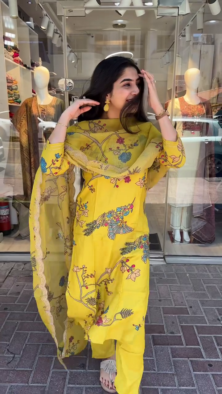 Mustard Yellow Cotton Kurta Set Colorful Floral and Botanical Print with Embroidered Neckline, Paired with Matching Pants and a Coordinated Printed Dupatta Accentuated with Scalloped Detailing – Perfect for Summer Festivities and Everyday Elegance