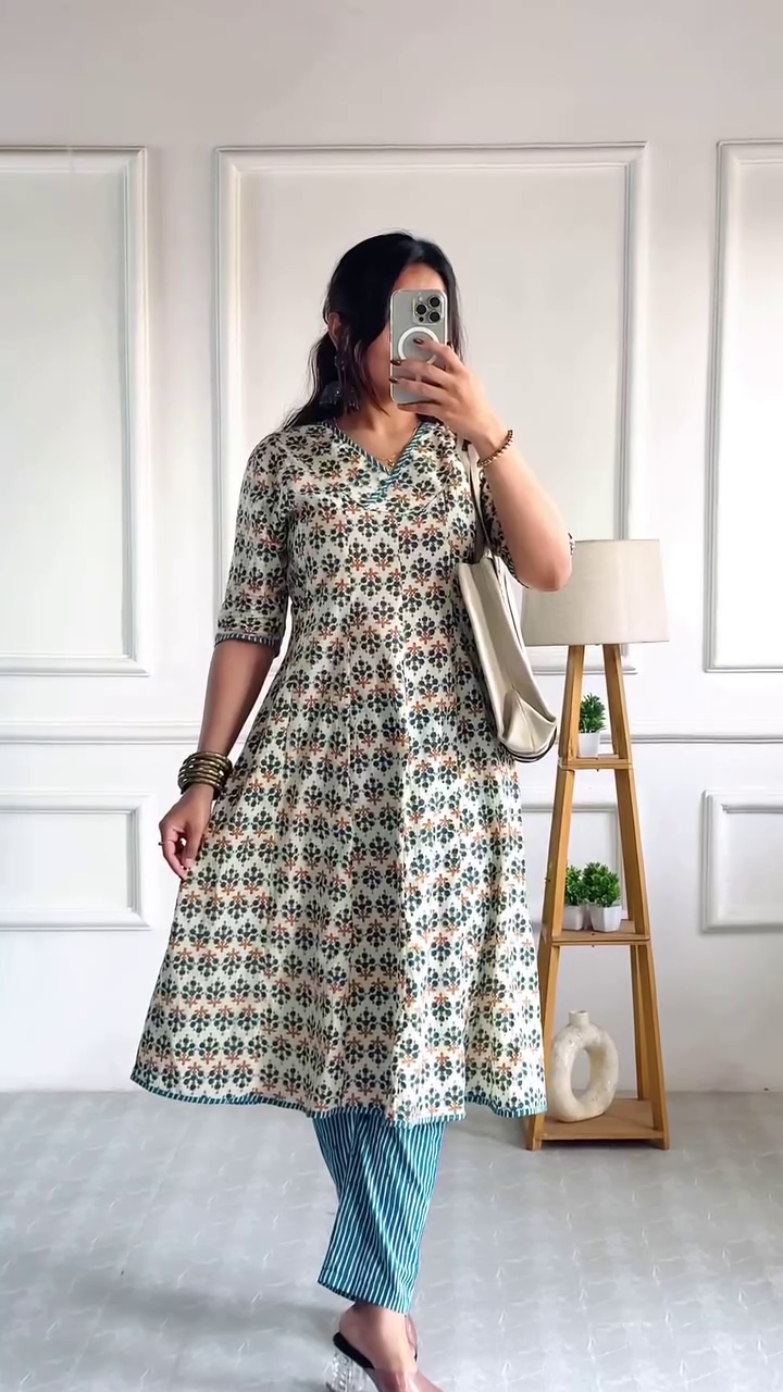 Halter-Neck Flared Indo-Western Jumpsuit with Layered Detailing and Chic Sleeveless Design Paired with Printed V-Neck Anarkali Kurti Featuring Floral Motifs and Blue Striped Pants for a Contemporary Ethnic Look