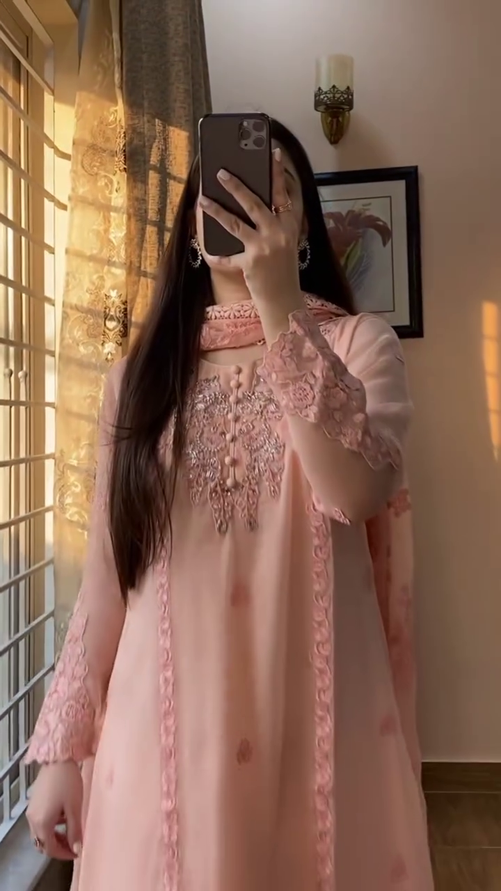 Elegant baby pink suit set in sheer chiffon featuring intricate lace and thread embroidery – A breezy, feminine look perfect for festive mornings and daytime gatherings.