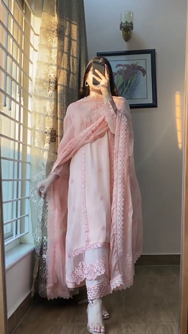 Elegant baby pink suit set in sheer chiffon featuring intricate lace and thread embroidery – A breezy, feminine look perfect for festive mornings and daytime gatherings.